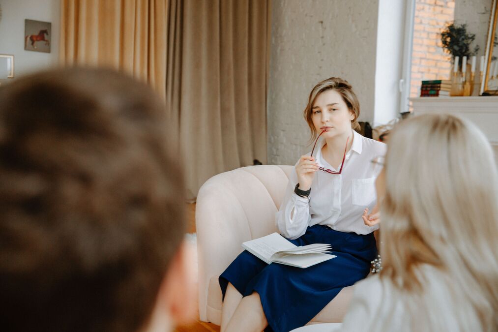 A professional counselor demonstrating core career counselling skills while mentoring an adult career switcher in an office setting.